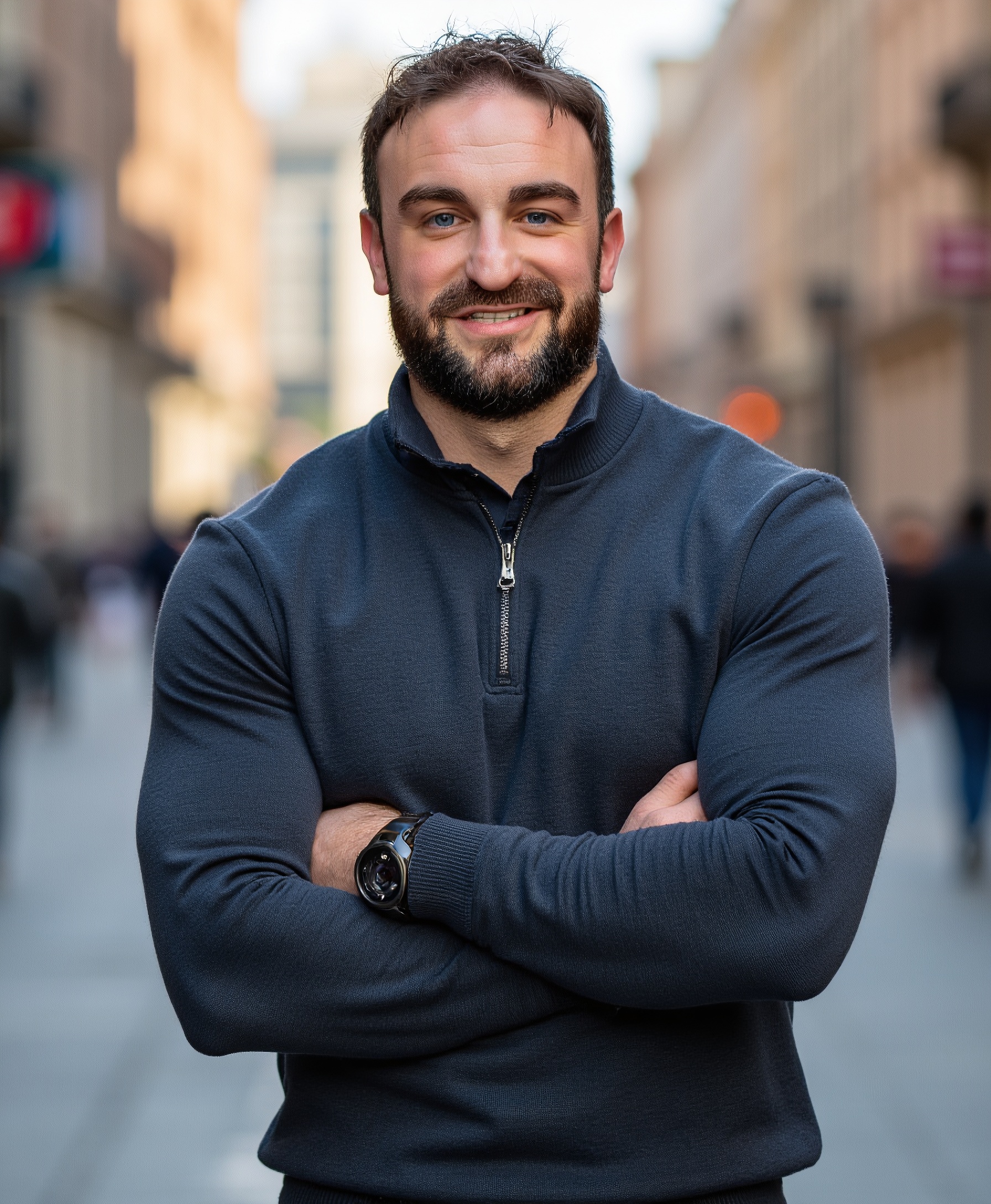 nic arms crossed blue sweater