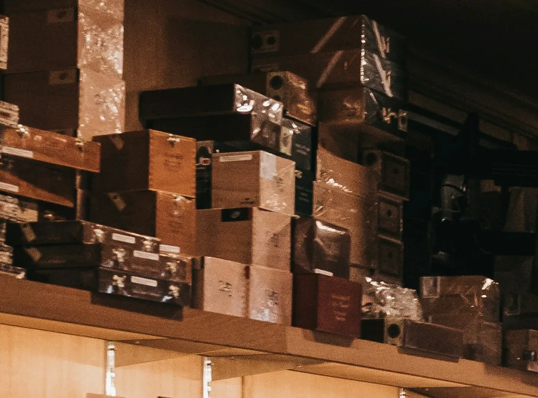 Boxes of cigars stacked on shelves in a retail humidor